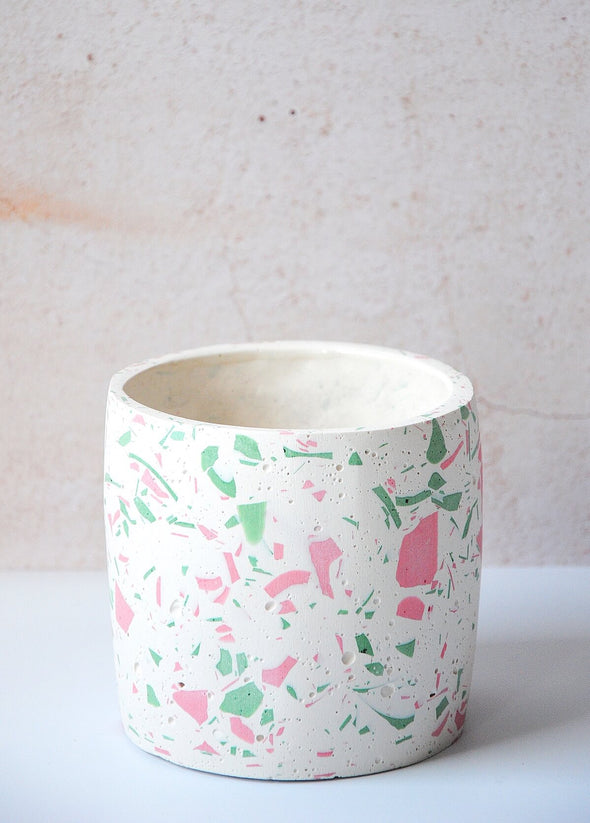 Terrazzo planter handmade by Salt Studios. Featuring a white base with pink and green terrazzo detail. Twelve centimetres tall and twelve centimetres wide.