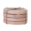 A set of four rose coloured marble coasters, stacked on top of each other and presented tied up with string.