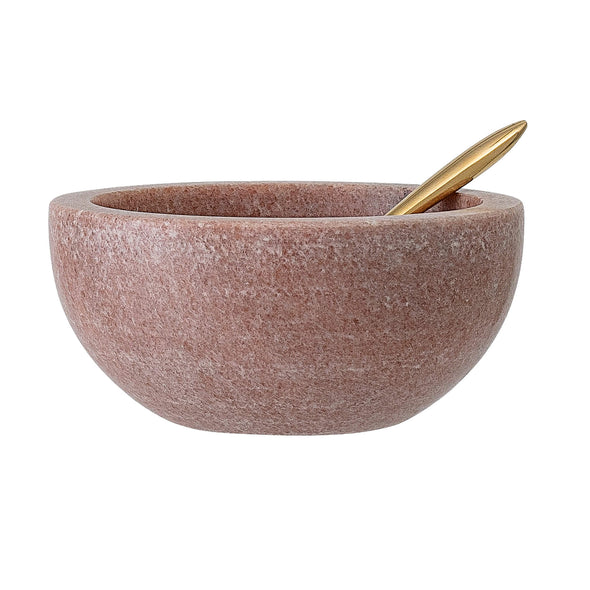 A pink marble condiment bowl with a brass spoon resting inside. The bowl has a width of ten centimetres and height of five centimetres.