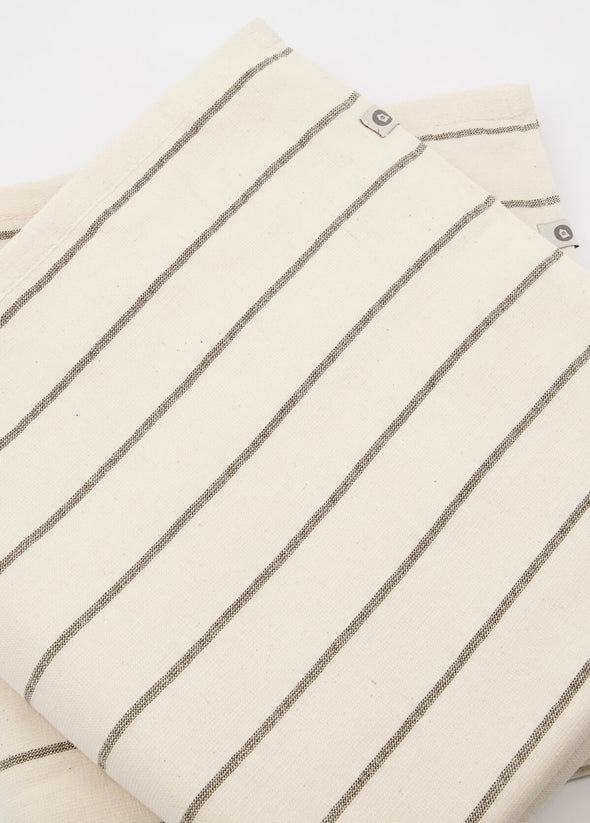 Close up of two folded bath towels in a cream and grey stripe design.