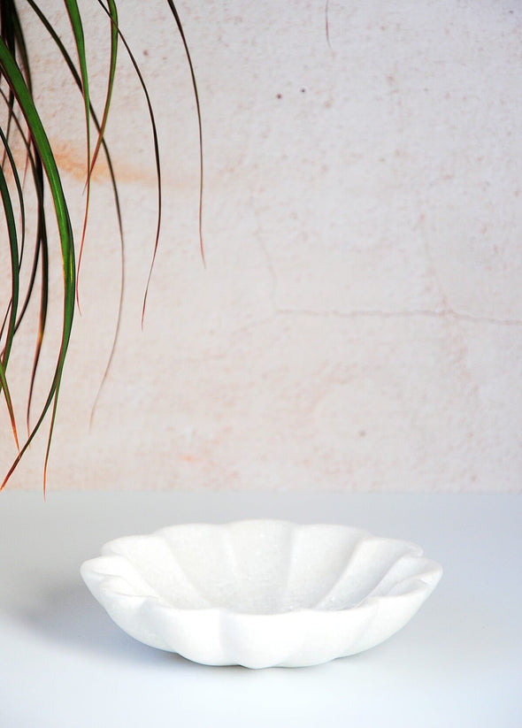 White marble fluted dish. Height four centimetres, width fifteen centimetres.
