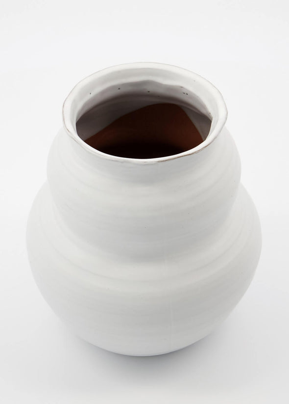 Ceramic vase with an organic rounded shape and simple white glaze. The vase is 19cm tall and 17cm wide